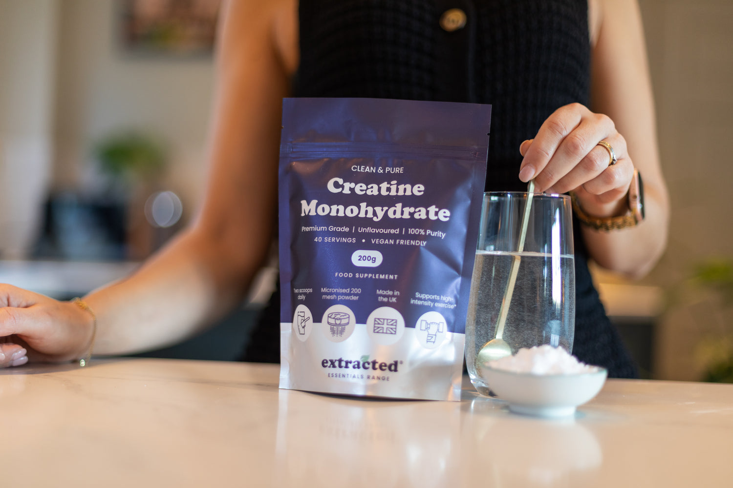 A woman stirring powder into a glass