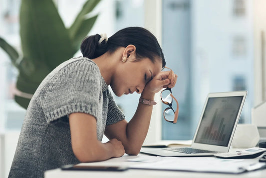 woman looking very stressed holding her head