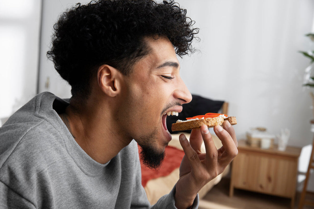 A man eating a piece of toast