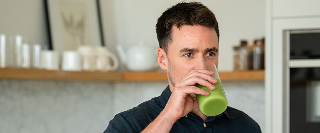 A woman holding supplement capsules